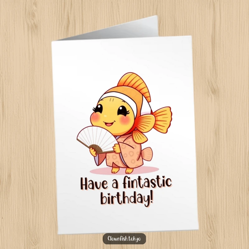 Funny Free Printable birthday card featuring a smiling clownfish in a patterned kimono, gracefully holding a delicate paper fan.